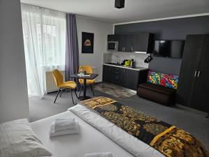 a hotel room with a bed and a kitchen at Třeboňské Apartmány in Třeboň