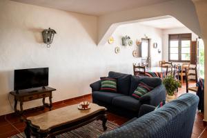 a living room with a couch and a tv at Dom Nuno by Horta da Moura in Monsaraz