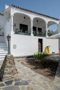 a white house with a porch and a balcony at Dom Nuno by Horta da Moura in Monsaraz
