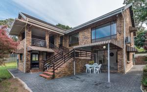 a brick house with a staircase and a patio at The 3rd Leg Bed and Breakfast in Pennington