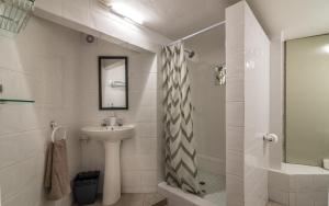 a white bathroom with a sink and a shower at The 3rd Leg Bed and Breakfast in Pennington +16 photos