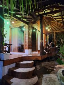 a room with stairs leading to a house at Tropical Jungle lodge & Jungle trekking in Bukit Lawang