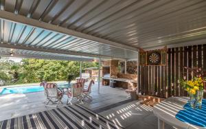 a patio with a table and chairs and a pool at The 3rd Leg Bed and Breakfast in Pennington