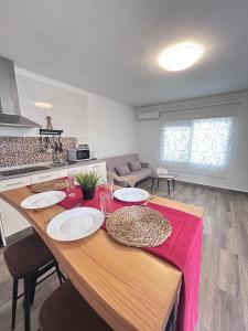 a kitchen with a table with plates on it at Apartamento Empul Barrosa Beach in Novo Sancti Petri