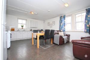 a kitchen and living room with a table and a couch at Ocean Quay in Greenock