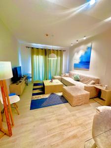 a living room with a couch and a table at Fouka bay service appartment FOR Families only in Marsa Matruh