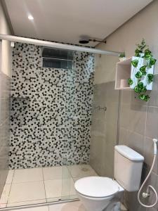 a bathroom with a toilet and a glass shower at RODRIGUES CASA de TEMPORADA em Barreirinhas in Barreirinhas +12 photos