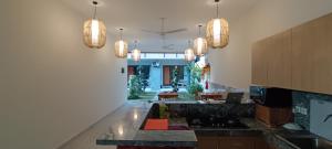 a kitchen with pendant lights and a counter top at Kubunaku Sanur Bali in Sanur