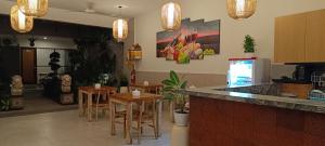 a restaurant with a bar with tables and chairs at Kubunaku Sanur Bali in Sanur