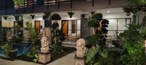 a building with a bunch of plants in it at Kubunaku Sanur Bali in Sanur