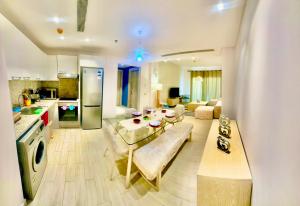a kitchen and a living room with a table and a couch at Fouka bay service appartment FOR Families only in Marsa Matruh