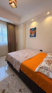 a bedroom with a bed with a butterfly picture on the wall at Serenity Residence in Alanya +16 photos