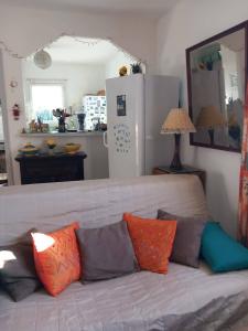 a living room with a couch with colorful pillows at Villa Cardicciosa in Ghisonaccia