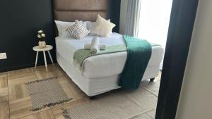 a bedroom with a bed with two teddy bears on it at Midrand Stylish 1Bedroom Escape in Midrand +45 photos