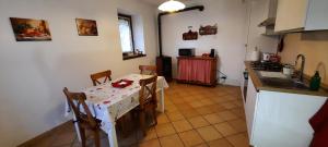 a kitchen with a table with chairs and a sink at L'incantevole vista in Colico +25 photos