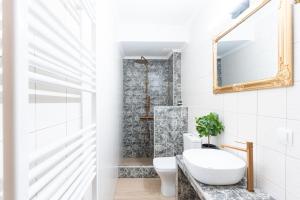 a bathroom with a sink and a toilet and a mirror at Lume in Metsovo