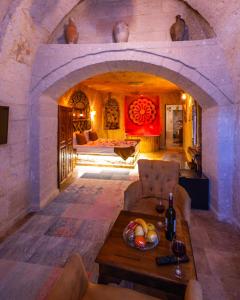 a room with an archway with a table and a bed at Bayar Cave Suites Special Class in Ürgüp
