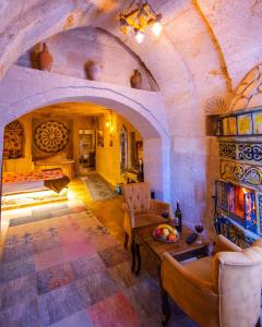a living room with a table and chairs in a building at Bayar Cave Suites Special Class in Ürgüp +118 photos