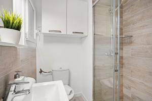 a bathroom with a toilet and a glass shower at 4Brothers by 3VILLAS in Cala en Porter