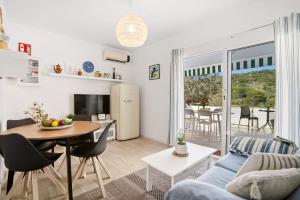 a living room with a blue couch and a table at 4Brothers by 3VILLAS in Cala en Porter +22 photos