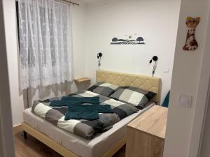 a bedroom with a bed and a window at Apartmány Polná na Šumavě in Svíba