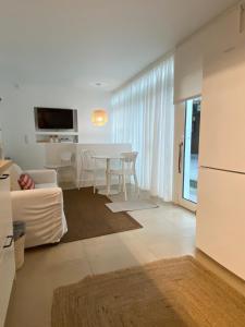 a kitchen and living room with a table and chairs at CHC Rochinha Studio in Funchal