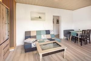 a living room with a couch and a table at Fewo zum Eisenstollen in Balve +13 photos