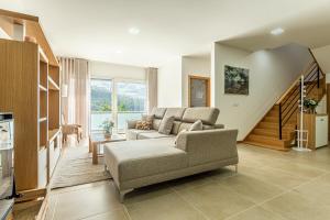 a living room with a couch and a staircase at Casa Manecas by Hostiva in Reriz