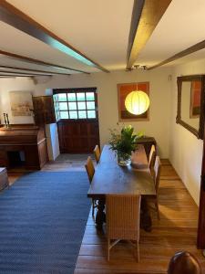 a dining room with a table with chairs and a piano at R2R - Finca Ranapega - 34A03 in Escamprero