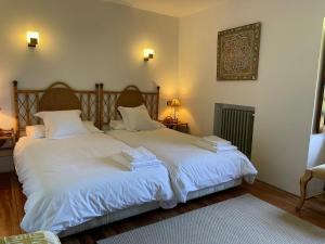 a bedroom with two beds with white sheets at R2R - Finca Ranapega - 34A03 in Escamprero