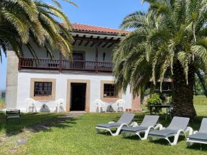 a group of lawn chairs in front of a house at R2R - Finca Ranapega - 34A03 in Escamprero