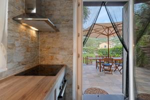 an outdoor kitchen with a view of a patio at Casa Due Ulivi in Lavagna