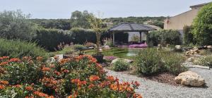 a garden with a pond and a gazebo at Une Belle Histoire in Argelliers