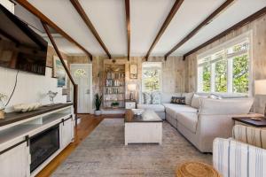 a living room with a couch and a table at Walk to Oceanside Beach in Wellfleet +30 photos