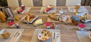 a table with bread and plates of food on it at Une Belle Histoire in Argelliers