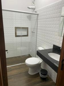 a bathroom with a toilet and a sink at CMS PLAZA Hotel in Serrana