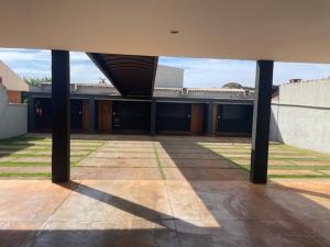a view of a building with columns in a courtyard at CMS PLAZA Hotel in Serrana
