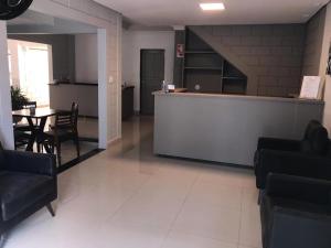 a lobby with a bar and a table and chairs at CMS PLAZA Hotel in Serrana