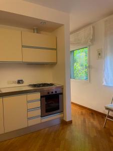 a kitchen with a stove and a window at La casa di Giulia in Genoa