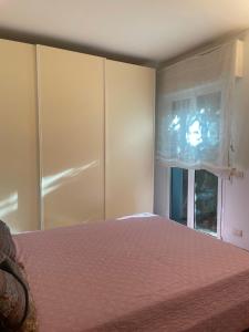 a bedroom with a bed and a window at La casa di Giulia in Genoa