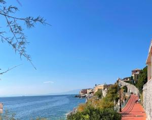 a view of the ocean from a hill with houses at La casa di Giulia in Genoa