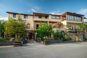 a building with a lot of plants in front of it at Aysel Inn House in Göreme