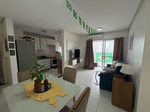 a kitchen and living room with a table and a dining room at Apartment in Ponta Negra in Manaus