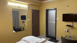 a bedroom with a bed and a mirror and a television at Hotel Surbhi in Shaikhpura +32 photos