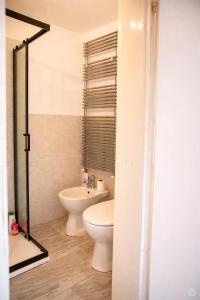 a bathroom with a toilet and a sink at La Dimora del Cadore in Domegge di Cadore +13 photos