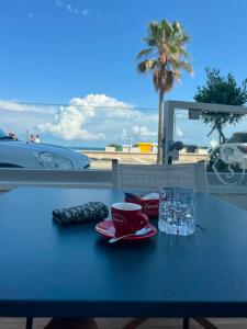 a table with a cup of water and a cup of coffee at Occhi sul mare in Termoli