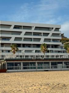 a building on the beach next to the sand at Occhi sul mare in Termoli