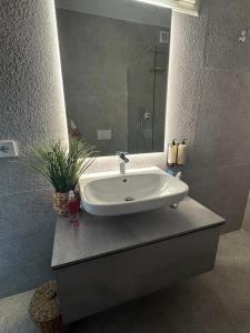 a bathroom sink with a mirror on a counter at Occhi sul mare in Termoli +36 photos