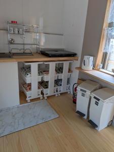 a kitchen with a counter and a table and some appliances at Kumanokodo KURA in Shingū