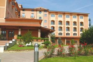 a large building with flowers in front of it at Relais La Fattoria in Melfi